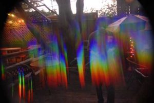Man stands in rainbow colored subtle energy. Not uncommon to get calls for energy work, energy healing involving clearing entities , demons, ghosts,